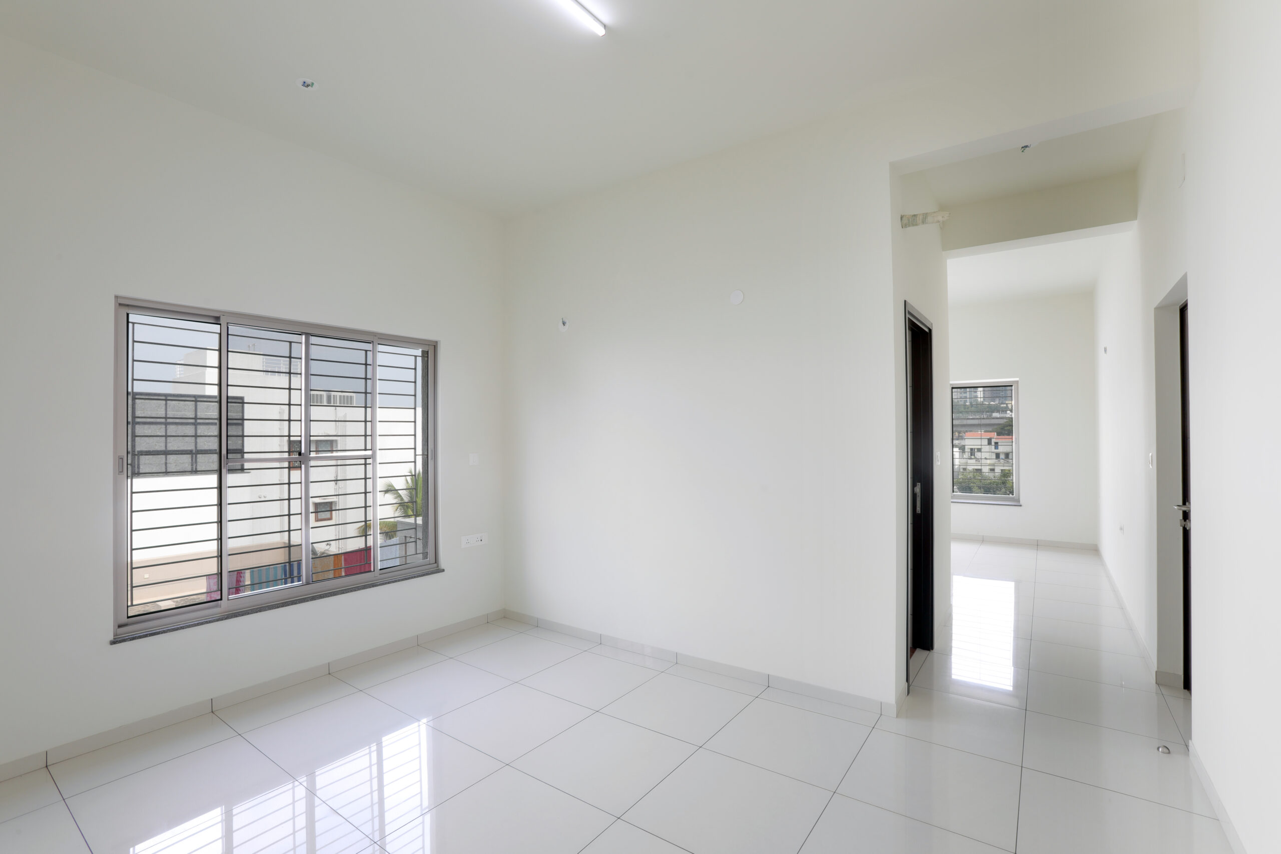 Modern living space with large windows at Mahalakshmi Layout - BHADRA LANDMARK