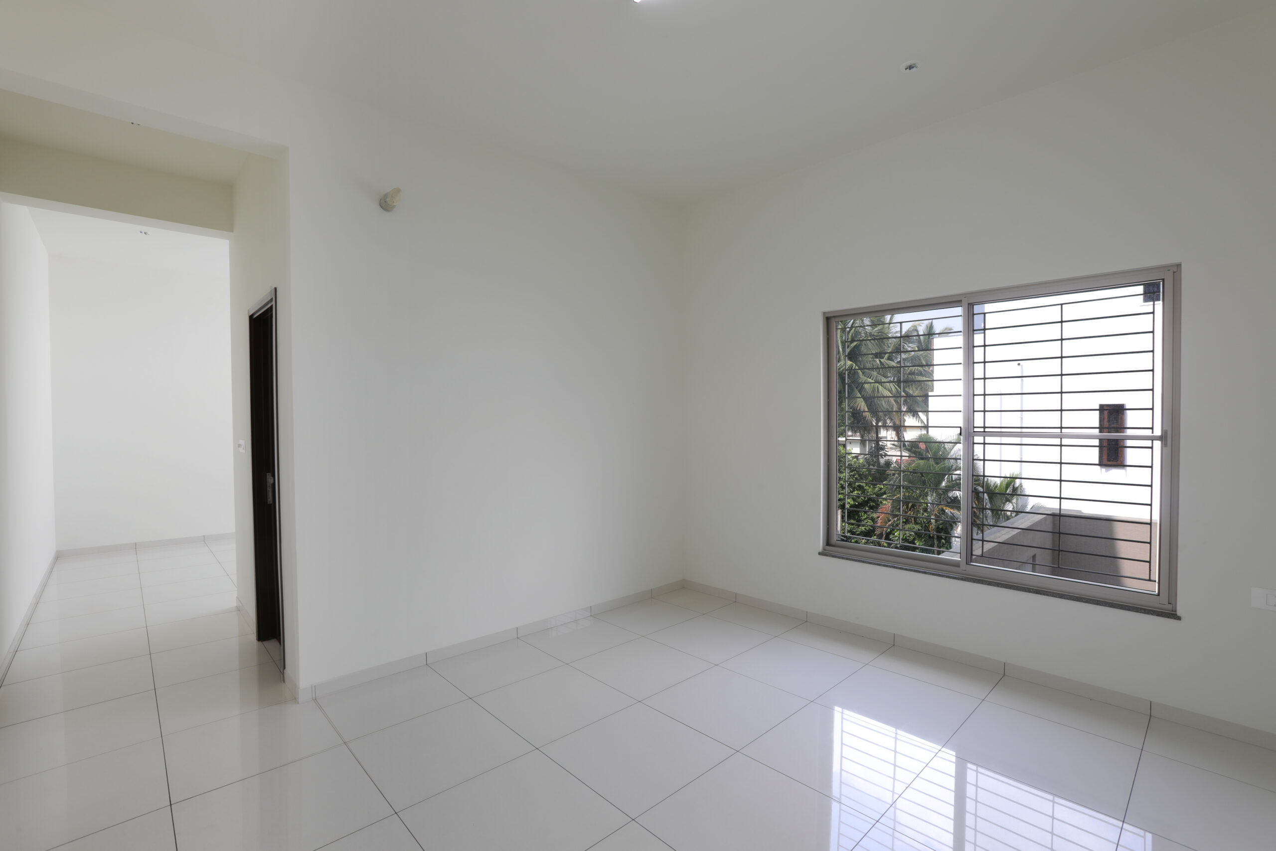 Well-lit bedroom interior at Mahalakshmi Layout - BHADRA LANDMARK Bengaluru